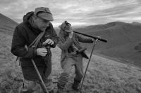 Kingie estate. Invergarry. Scottish highlands. Deer stalkers spying through telescope. Black and white