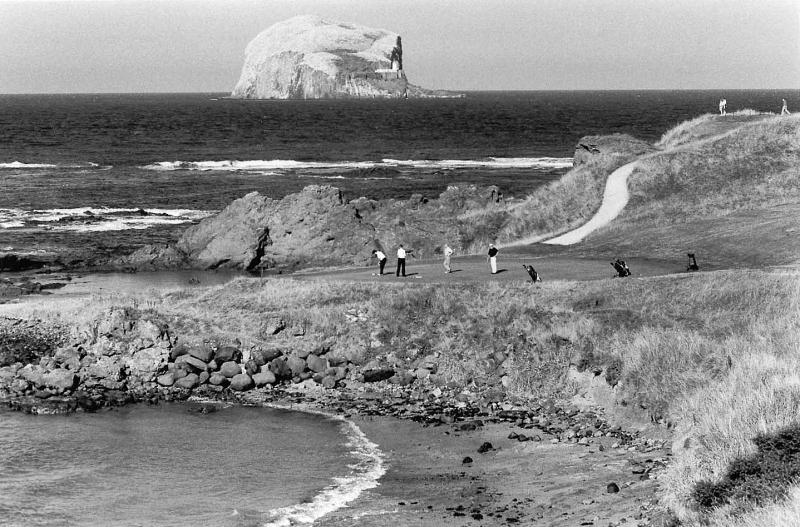 The Glen golf course with players. North Berwick. 13th green. Bass Rock.Black and white